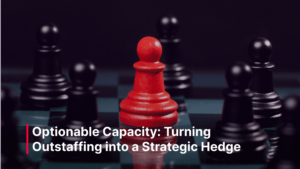 A red chess pawn stands prominently among black pawns on a chessboard, symbolizing strategic positioning and differentiation. Text overlay reads “Optionable Capacity: Turning Outstaffing into a Strategic Hedge.”